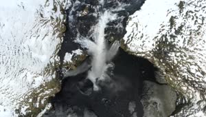 Free Video Stock top aerial shot of a waterfall in a winter forest Live Wallpaper