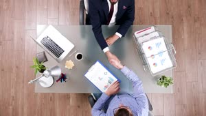 Free Video Stock top view of business handshake and client meeting Live Wallpaper