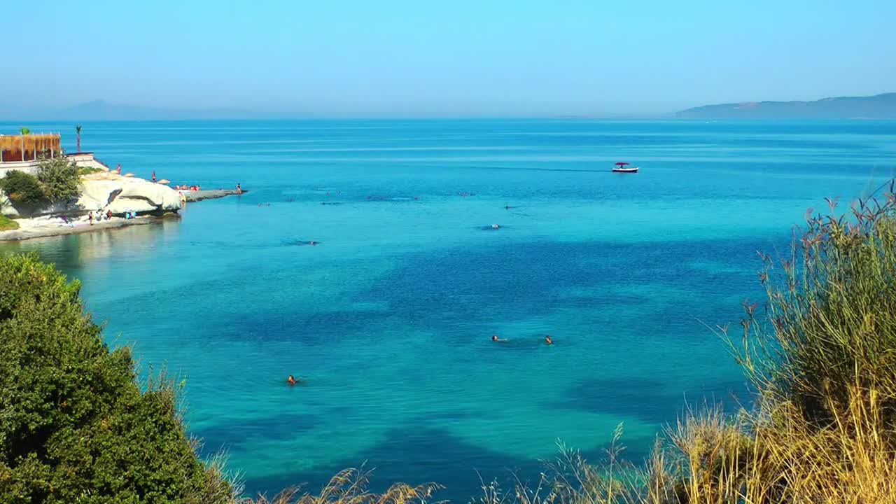 Download Free Video Stock tourist beach with clear water sea high view Live Wallpaper