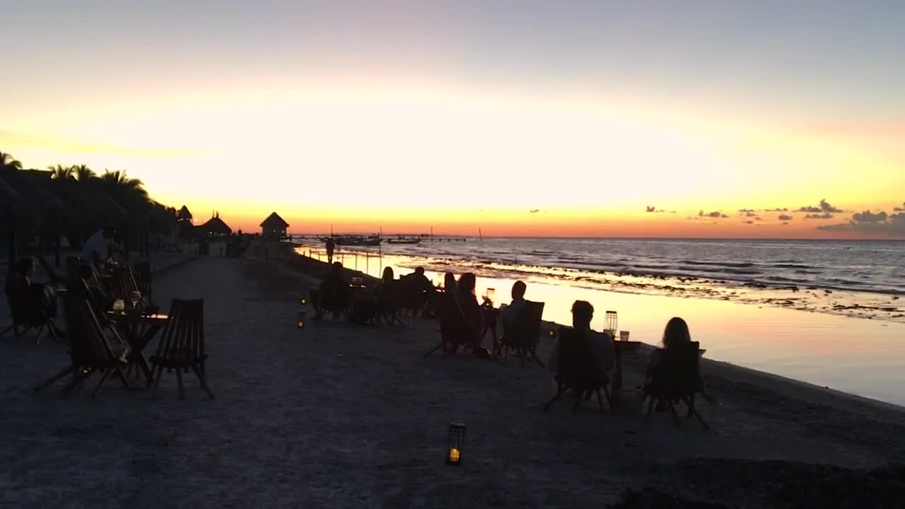 Download Free Video Stock tourists at a beach bar watching at sunset Live Wallpaper
