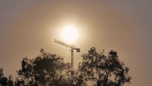 Free Video Stock tower crane during sunset seen in the distance Live Wallpaper