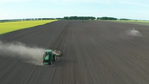 Free Video Stock tractor driving along a dusty field Live Wallpaper