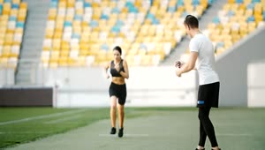 Free Video Stock trainer motivates athlete on running track Live Wallpaper