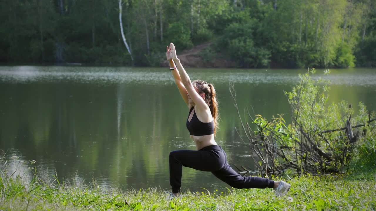 Download Free Stock Video Young Woman Practicing Yoga By The Lake Live Wallpaper