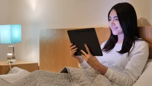 Free Stock Video Young Woman In Bed Using Her Tablet Before Sleeping Live Wallpaper