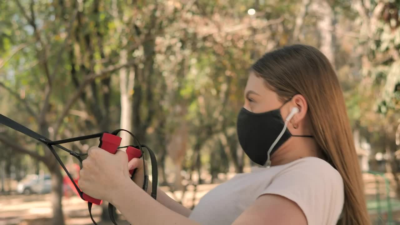 Download Free Stock Video Young Woman Exercising At Park Using Face Mask Live Wallpaper