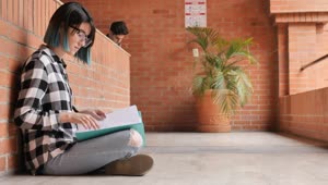 Free Stock Video Young Female Student Reviewing Her Notes At Her School Live Wallpaper