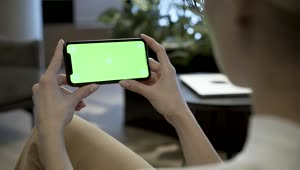 Free Stock Video Woman Watching A Mobile Phone With A Green Screen Live Wallpaper