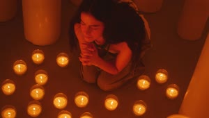 Free Stock Video Woman Praying Sitting On The Floor Among Many Candles Live Wallpaper