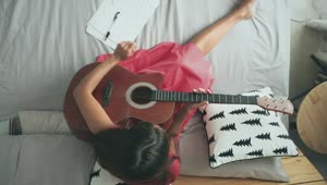 Free Stock Video Woman Playing The Acoustic Guitar On The Bed Live Wallpaper