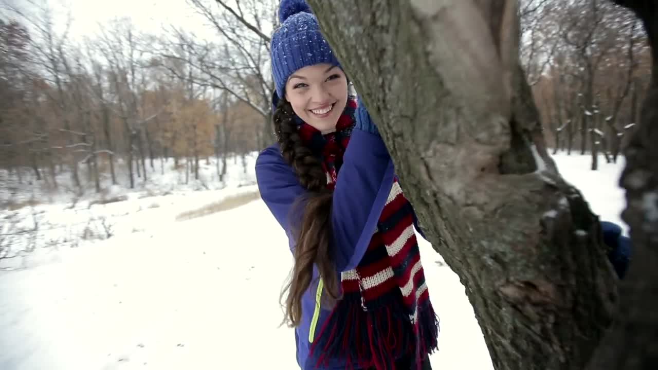 Download Free Stock Video Woman Playing Around A Tree During Winter Live Wallpaper