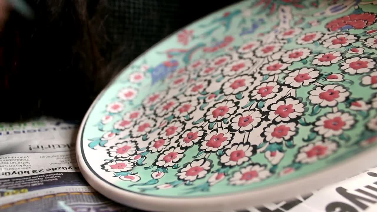 Download Free Stock Video Woman Painting Flowers Hand On A Large Plate Live Wallpaper