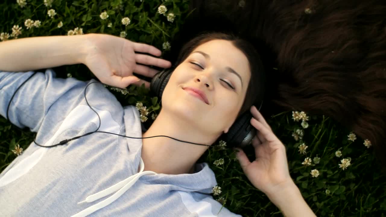 Download Free Stock Video Woman Enjoying Listening To Music In The Garden Live Wallpaper