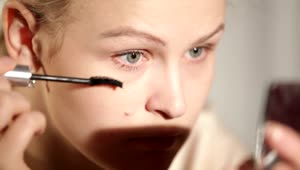   Stock Footage Woman Applying Makeup To Her Eyes Live Wallpaper