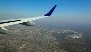   Stock Footage Wing View Of An Airplane Flying Above The City Live Wallpaper