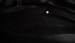   Stock Footage White Pearls On A Black Cloth Live Wallpaper