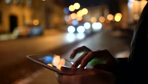   Stock Footage Using A Tablet On The Street By Night Live Wallpaper