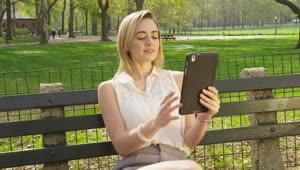   Stock Footage Using A Tablet On A Park Bench Live Wallpaper