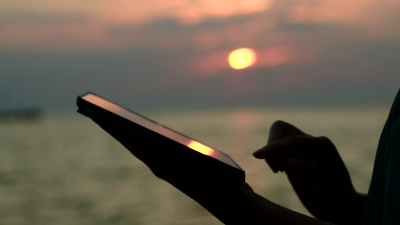 Download   Stock Footage Using A Tablet At Sunset Live Wallpaper