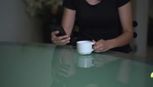  Stock Footage Upset Woman Checking A Cell Phone While Drinking Tea Live Wallpaper