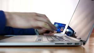   Stock Footage Typing Credit Card Information On A Laptop Live Wallpaper