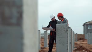   Stock Footage Two Workers With Blueprint In Construction Site Live Wallpaper