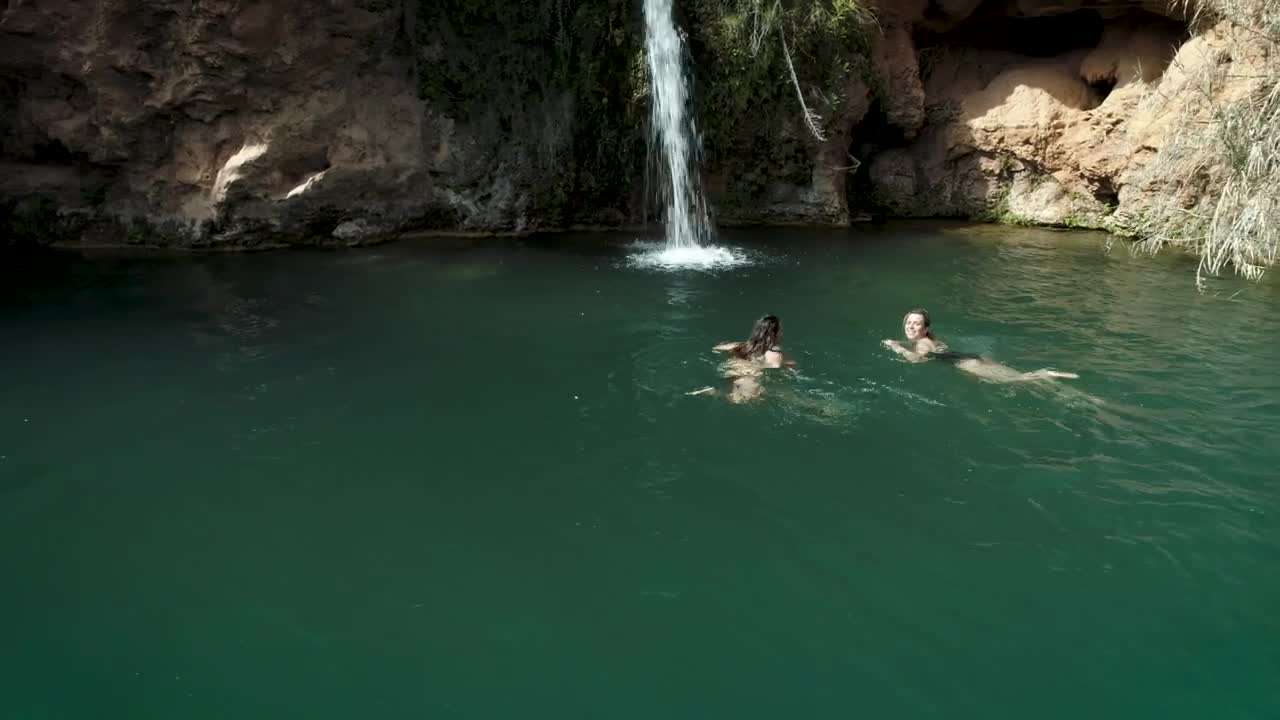 Download   Stock Footage Two Girls Swimming In A Pond With A Waterfall Live Wallpaper