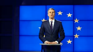   Stock Footage Tv News Presenter With Europe Flag Behind Live Wallpaper