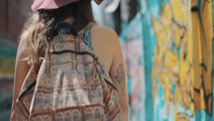 Stock Footage Woman With Backpack Walking Past Graffiti Live Wallpaper Free