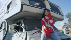 Stock Footage Woman Sitting On Hood Of Motor Home Live Wallpaper Free