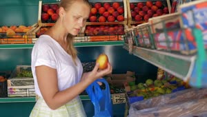 Stock Footage Woman Picking Fruit In A Small Shop Live Wallpaper Free