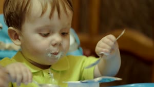 Stock Footage Young Boy Eating With Two Spoons Live Wallpaper Free
