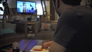 Stock Footage Young Man Eating While Watching Television Live Wallpaper Free