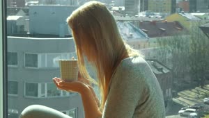 Stock Footage Woman Sipping Coffee Next To A Window Live Wallpaper Free