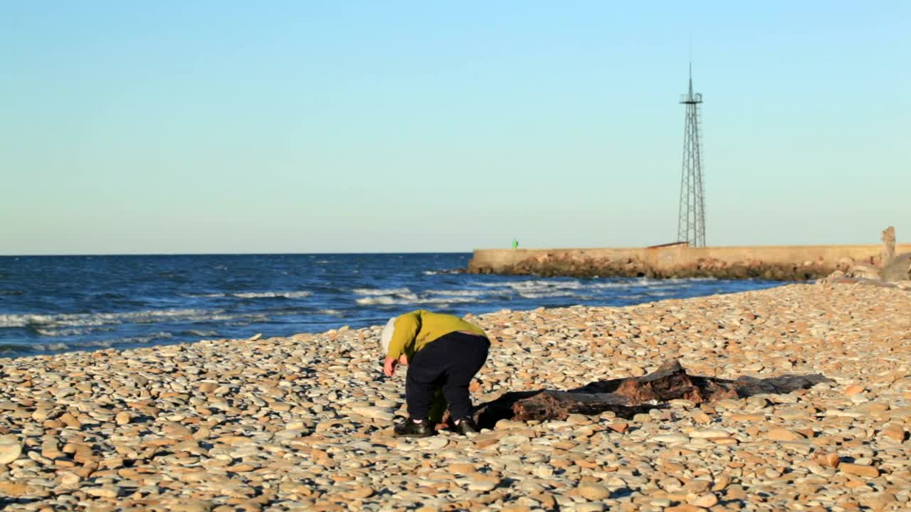 Download Stock Footage Young Boy Throwing Stones On The Beach Live Wallpaper Free