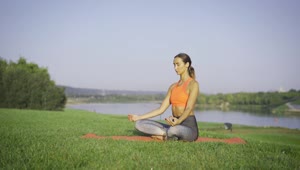Stock Footage Woman Meditating On The Grass Near The River Live Wallpaper Free