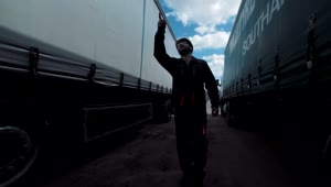 Stock Footage Worker Walking Between Two Freight Trucks Live Wallpaper Free