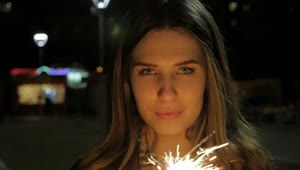Stock Footage Woman Holding Two Sparklers Live Wallpaper Free