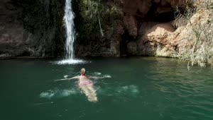 Stock Footage Woman Swimming In A Pond With A Waterfall Live Wallpaper Free