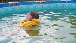 Stock Footage Young Boy With Inflatable Vest Swimming In The Pool Live Wallpaper Free