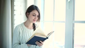 Stock Footage Woman Reading Book Near Bright Window Live Wallpaper Free