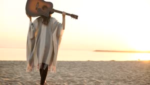 Stock Footage Woman Walks On Sunset Beach With Acoustic Guitar Live Wallpaper Free