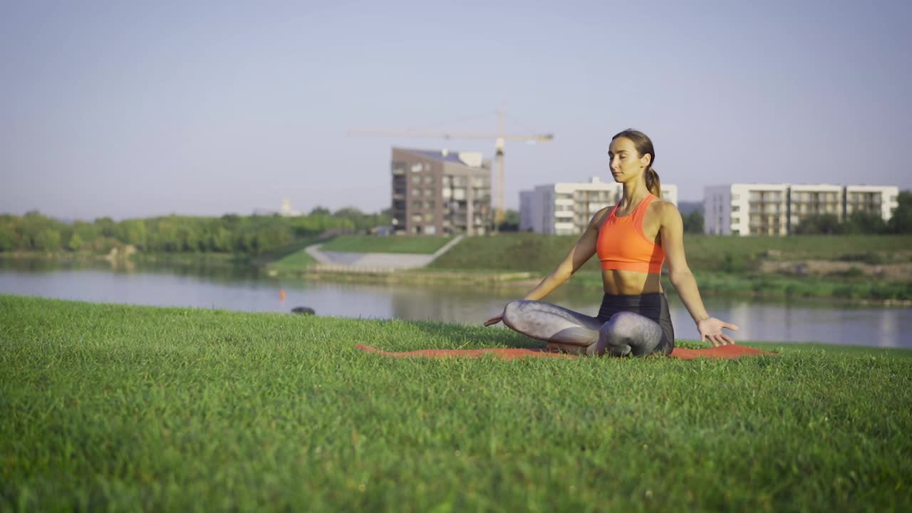 Download Stock Footage Woman Meditating On The Park By The River Live Wallpaper Free