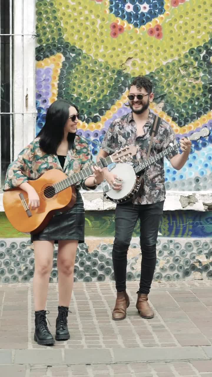 Download Stock Footage Young Man And Woman Playing Music On A Colorful Street Live Wallpaper Free