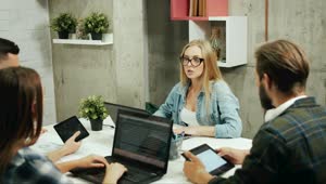 Stock Footage Young Business Team Discuss Design In Modern Office Live Wallpaper Free
