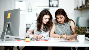 Stock Footage Young Women Talk About Design Project In Modern Office Live Wallpaper Free