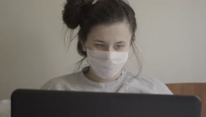 Stock Footage Woman With Laptop In Face Mask Sneezes Live Wallpaper Free