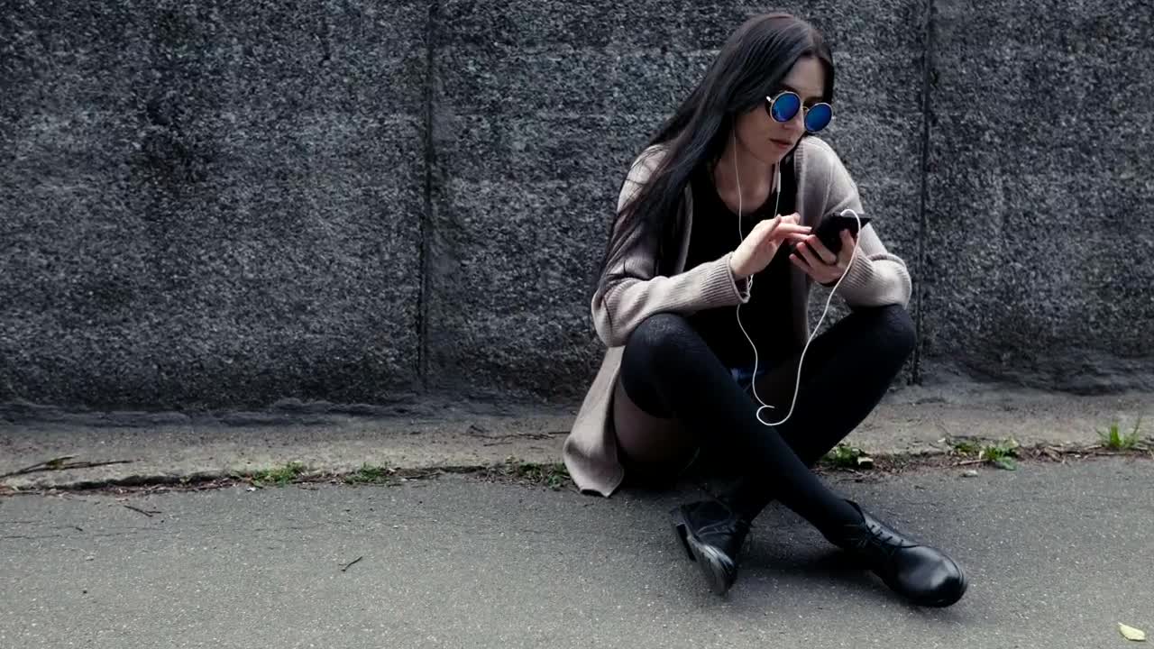 Download Stock Footage Woman Sitting With Her Phone Live Wallpaper Free