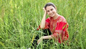 Stock Footage Woman Sitting In A Field Of Long Grass Live Wallpaper Free