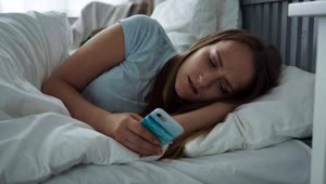Stock Footage Woman Using Her Phone In Bed Live Wallpaper Free